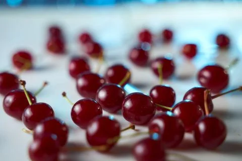 Group of cherry on a white background with shadows. Close-up. Blue Bokeh effe Stock Photos