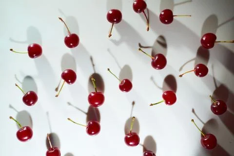 Group of cherry on a white background with shadows. Close-up. Top view. Stock-Fotos