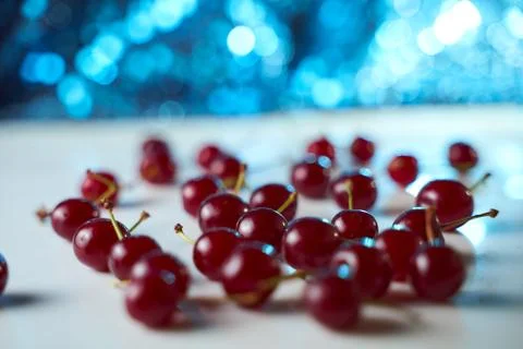 Group of cherry on a white background with shadows. Close-up. Blue Bokeh effe Stock Photos