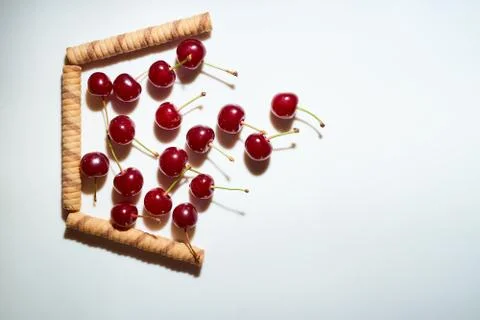 Group of cherry on a white background with shadows. Fall in the improvised ba Stock Photos