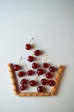 Group of cherry on a white background with shadows. Fall in the improvised ba Stock Photos