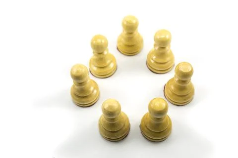 A group of chess pawns make groups to discuss strategies in a circle Stock Photos