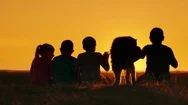 A Group Of Children Admire The Sunset In A Picturesque Place. A Dog Sits Next To Stock Footage
