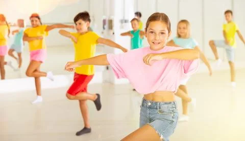 Group of children are learning dance moves in modern studio Stock Photos