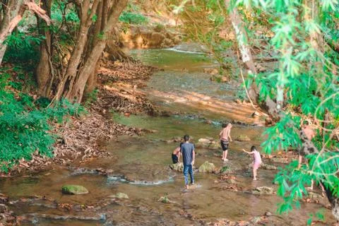 A group of children are walking to explore the nature of the stream at Hin Da Stock Photos