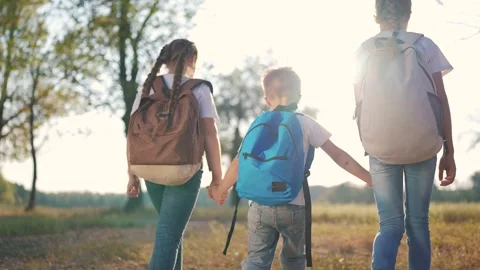Group of children are walking in a forest with backpacks. Backpack nature child Stock Footage 320834649