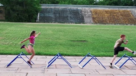 Group of children athletes in training for run with obstacles on old stadium Video stock 133370267