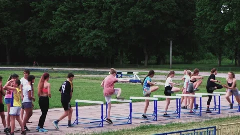 Group of children athletes in training for run with obstacles on old stadium Video stock 133990953