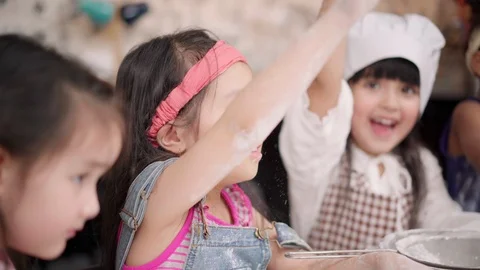 Group of children baking cake together in classroom. Stock Footage 109990122