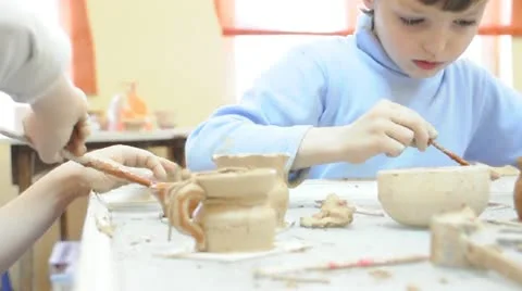 Group of children brushing their pottery Stock Footage 10769495