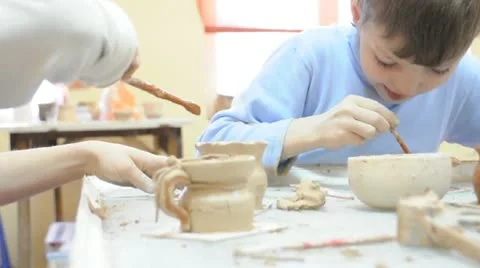 Group of children brushing thier pottery Stock Footage 10769490