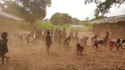 A group of children cleans the courtyard with branches Stock Footage 106515656