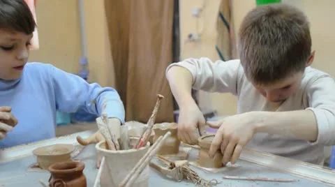 Group of children decorating their pottery at clay school Stock Footage 10790032