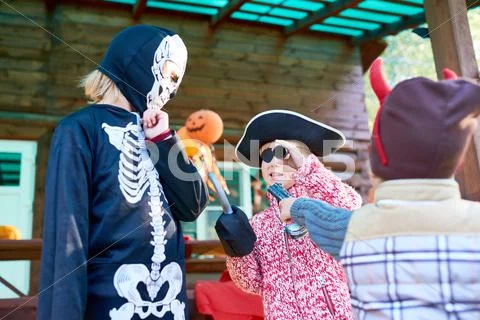 Group of children in Halloween costumes playing together Stock Photos