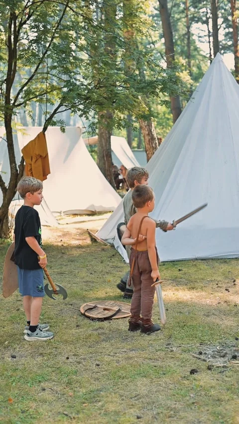 A group of children, including boys dressed in basic tunics and shorts, Vidéo 345035838