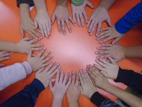 Group of children joining hands to do a competitive teamwork challenge Stock Photos