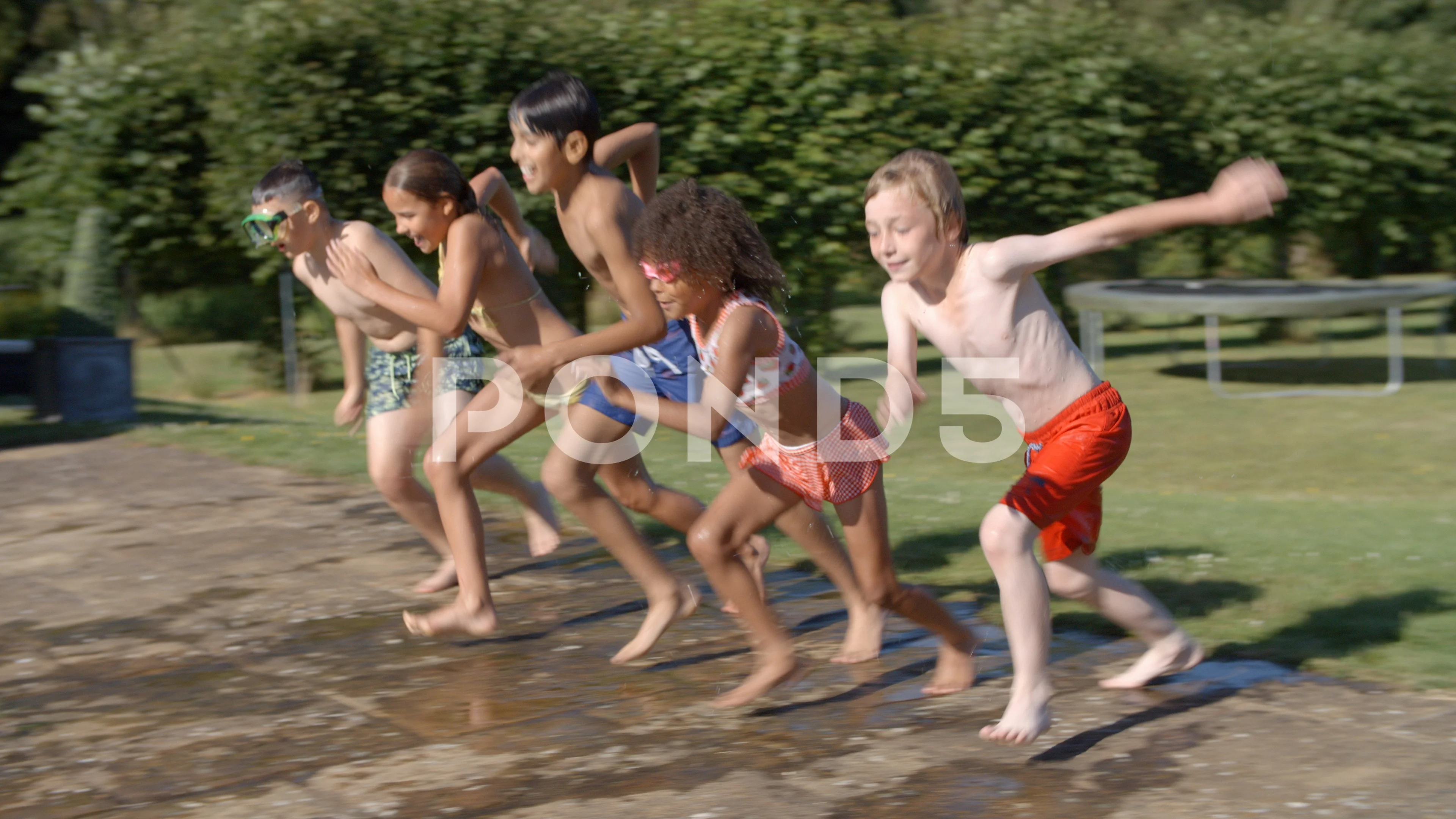 Group of five happy children jumping outdoors., Group of fi…