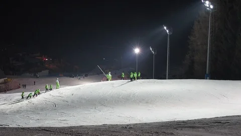 Group of children is learning to ski with the ski instructor in the evening 動画素材 124661043