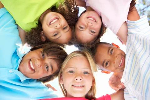 Group Of Children Looking Down Into Camera Stock Photos