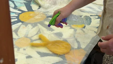 A group of children make a toy from wool, wet felting a blank and squeeze water  Stock Footage 306536812