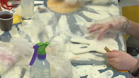 A group of children make a toy from wool, wet felting a blank and squeeze water  스톡 동영상 306537538