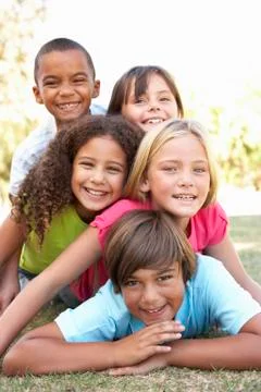 Group Of Children Piled Up In Park Stock Photos