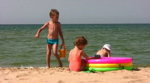Group children play on beach Stock Footage