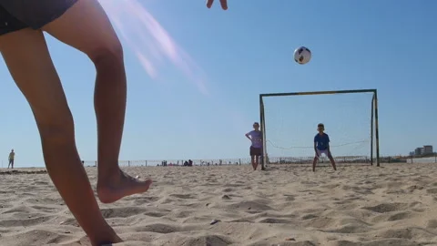 A group of children playing ball on the beach Stock Footage 96419315
