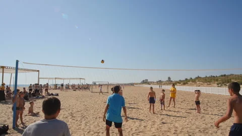 A group of children playing ball on the beach Stock Footage 96419378