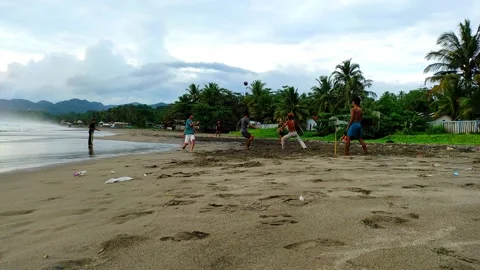 A group of children playing ball on the beach Stock Footage 233758328