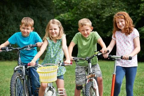 Group Of Children Playing On Bikes And Scooter Stock Photos