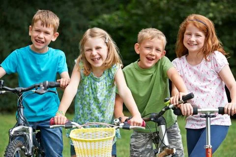 Group Of Children Playing On Bikes And Scooter Stock Photos