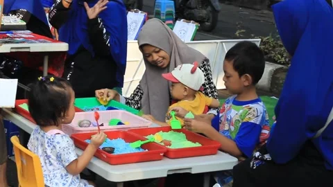 Group of children playing a game of making cake replicas Stock Footage 296133466