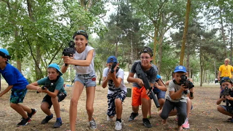 A group of children playing laser tag. children run together. Stock Footage 96419450