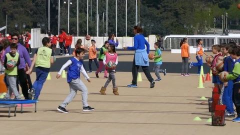 A group of children at school playing training basketball together at playground Stock Footage 129413301