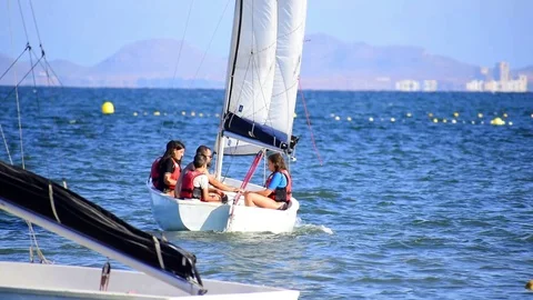 Group of children taking initiation class of sailing in Spain in Summer. Stock Footage 116899703