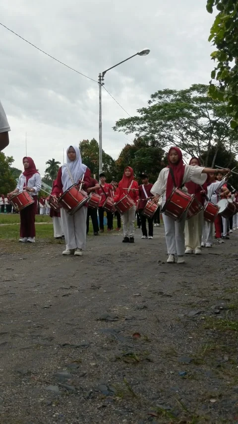 A group of children walking around playing drum band Stock Footage 282416063