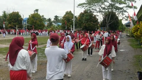 A group of children walking around playing drum band Stock Footage 282416072