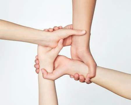 Group of children's hands holding on to each other, symbolizing work in team and Stock Photos