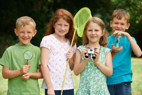 Group Of Childrfen Exploring Nature Together Stock Photos