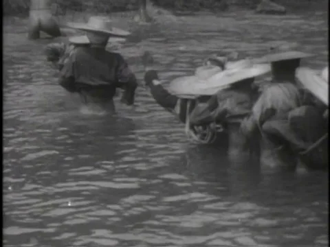 Group of Chinese men pull heavy load uphill in the 1940s. Stock Footage 75288665
