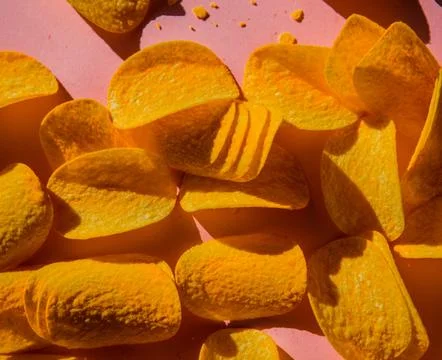 Group of chips on pink background. Stock Photos