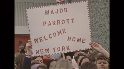 A group of citizens await the return of American soldiers at an airport in the Stock-Footage 111236680