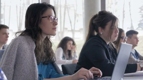 Group of classmates enrolled in a study course sitting in the classroom Stock Footage 69932444