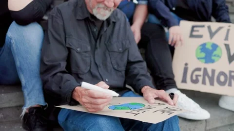 Group of climate change activists making banners for global warming protest Stock Footage 237403812
