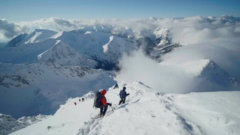 A group of climbers ascending a mountain in winter Stock Footage 104501984