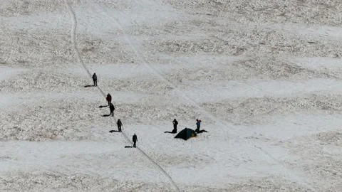A group of climbers cross the glacier close to a camp Stock Footage 137394281