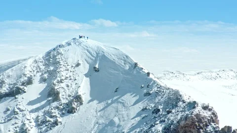 Group of climbers reaching snowy mountain summit Stock Footage 337010239