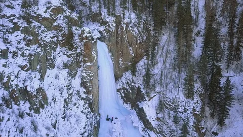Group of climbers is trying to conquer the top icy wall. Aerial view. Stock-Footage 104837642