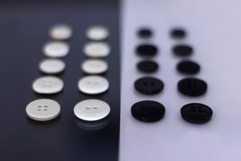A group of clothing buttons lined up in rows Stock Photos